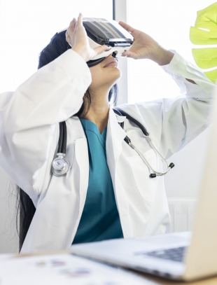 female doctor using virtual reality glasses technology in hospital
